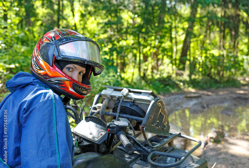 young people riding ATV on dirt track young people riding ATV on dirt track