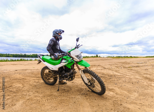Fototapeta Naklejka Na Ścianę i Meble -  Motocross racers on landscape