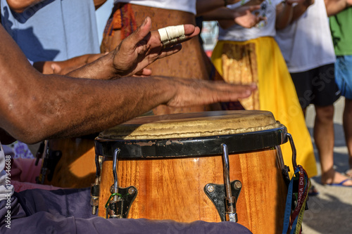 Fotografie, Obraz Percussionist playing atabaque during folk samba performance on the streets of R