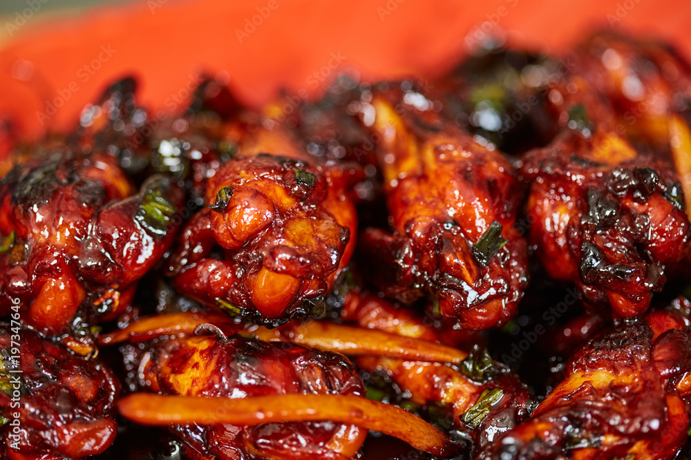 Caramelized chicken wings in closeup Caramelized chicken wings in closeup