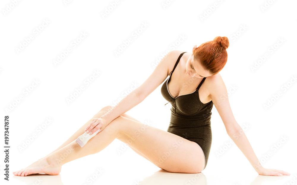 Woman shaving her legs with electric razor Woman shaving her legs with electric razor