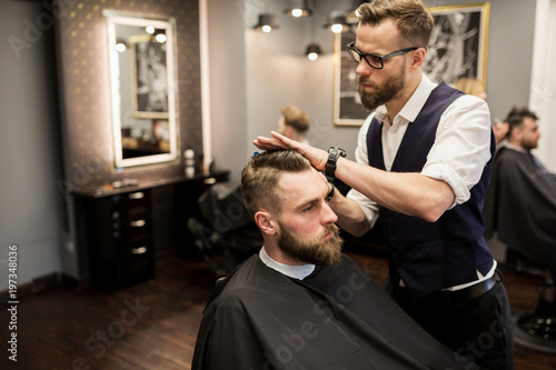 Focused barber working on customer hair