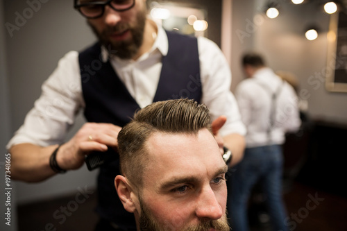 Barber styling customer hair