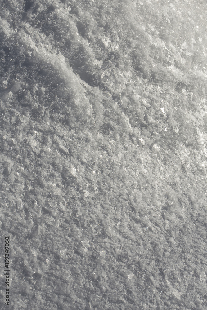 Beautiful, large crystals of frost lay on the cold snow in the early morning in the backlit sunlight. Close-up. Beautiful, large crystals of frost lay on the cold snow in the early morning in the backlit sunlight. Close-up.