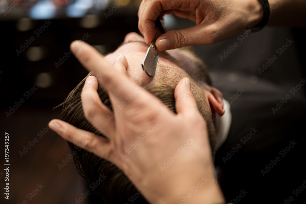 Customer being shaved by professional barber