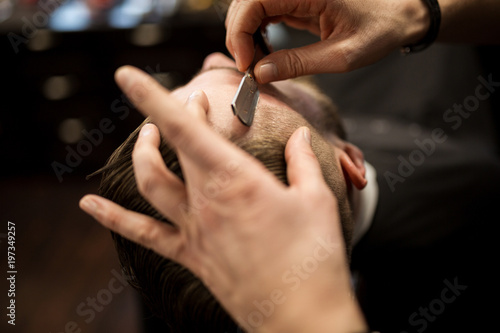Customer being shaved by professional barber