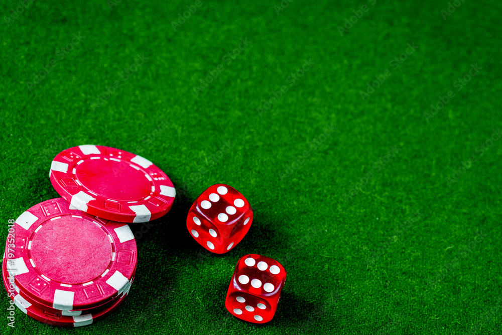 poker chips and dice on green background top view poker chips and dice on green background top view
