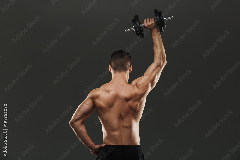 Back view portrait of a young shirtless muscular sportsman