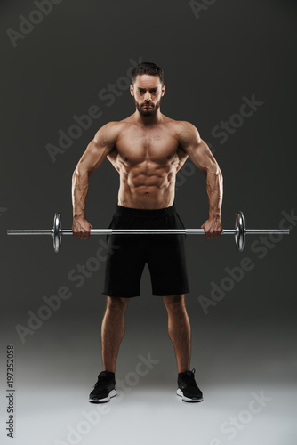Full length portrait of a strong shirtless muscular sportsman © Drobot Dean
