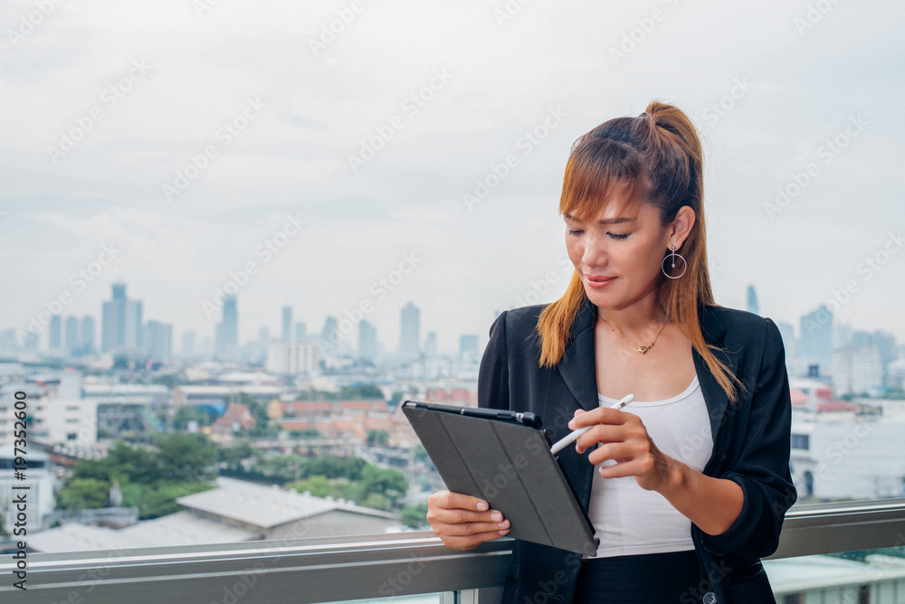 Fototapeta premium vintage style, Young business woman with tablet in the office against panoramic windows