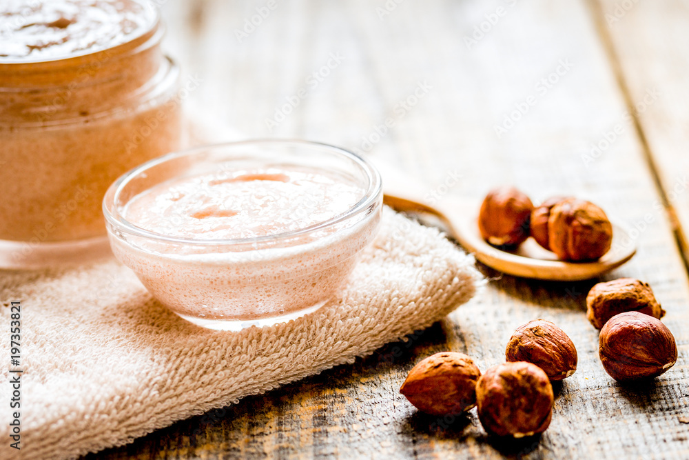 spa concept with hazel-nuts and scrub on wooden background spa concept with hazel-nuts and scrub on wooden background