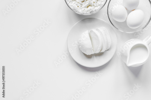 Fresh dairy products on white table background top view mockup