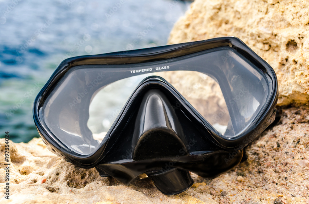 silicone mask for scuba diving or snorkeling on yellow stones a