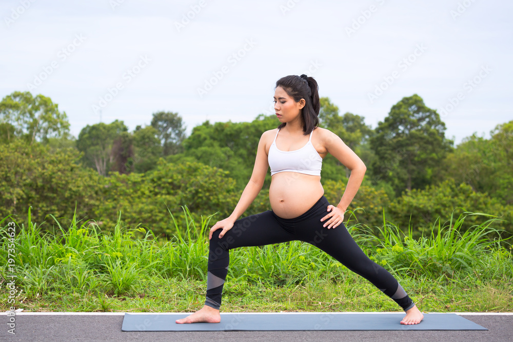 Fototapeta premium Pregnant woman doing yoga