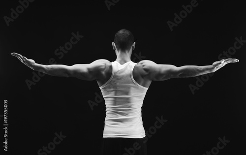 Unrecognizable man shows strong back muscles closeup