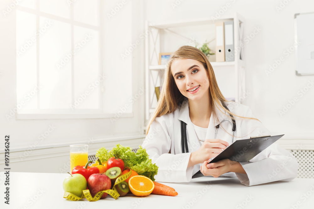 Nutritionist desk with fruit and measuring tape Nutritionist desk with fruit and measuring tape