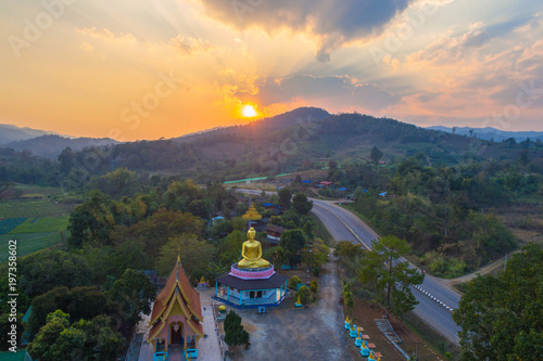 aerial photography the golden buddha statue at wat Sirattanan Mongkol near Mae Kajan Hot Spring. Wiang Pa Pao Chiang Rai Thailand.