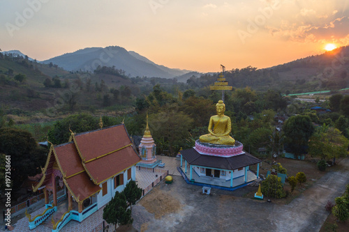 aerial photography the golden buddha statue at wat Sirattanan Mongkol near Mae Kajan Hot Spring. Wiang Pa Pao Chiang Rai Thailand. photo