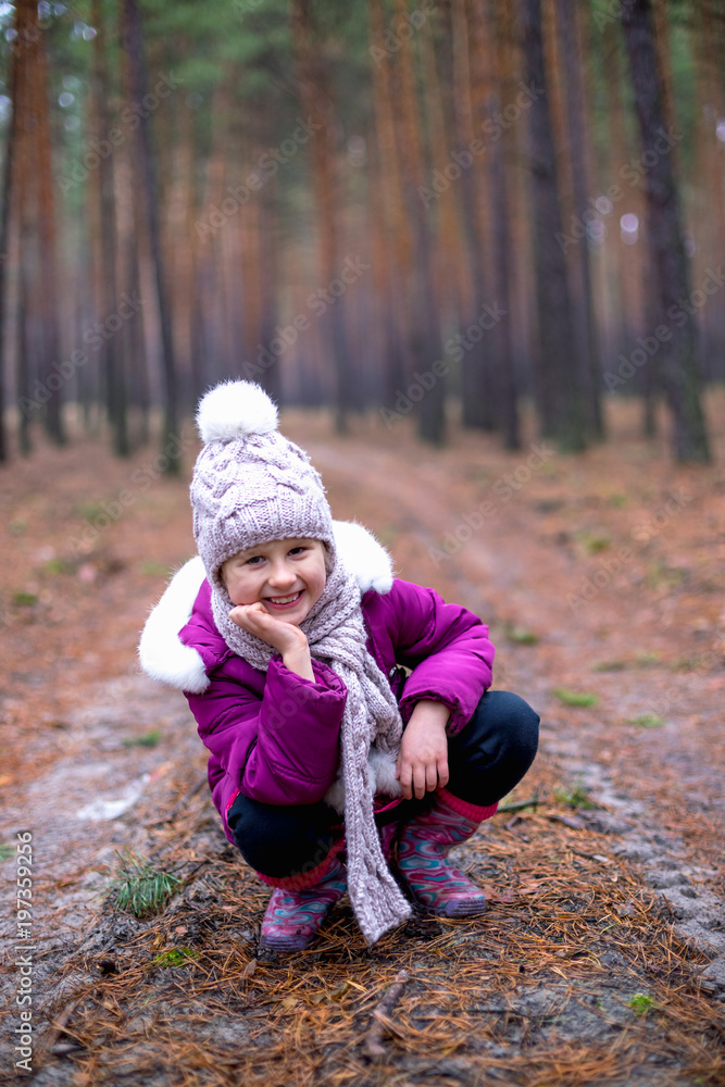 Little cute little girl posing on the road in the autumn forest Little cute little girl posing on the road in the autumn forest