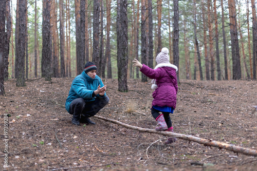 Father and his daughter in autumn forest