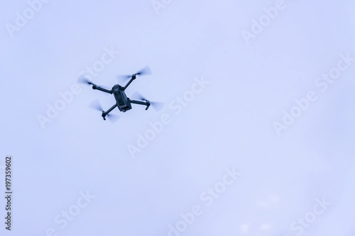 flying drone against blue sky