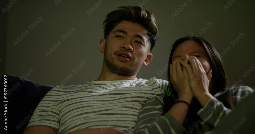 4K Affectionate young couple watching scary movie at home at night 4K Affectionate young couple watching scary movie at home at night