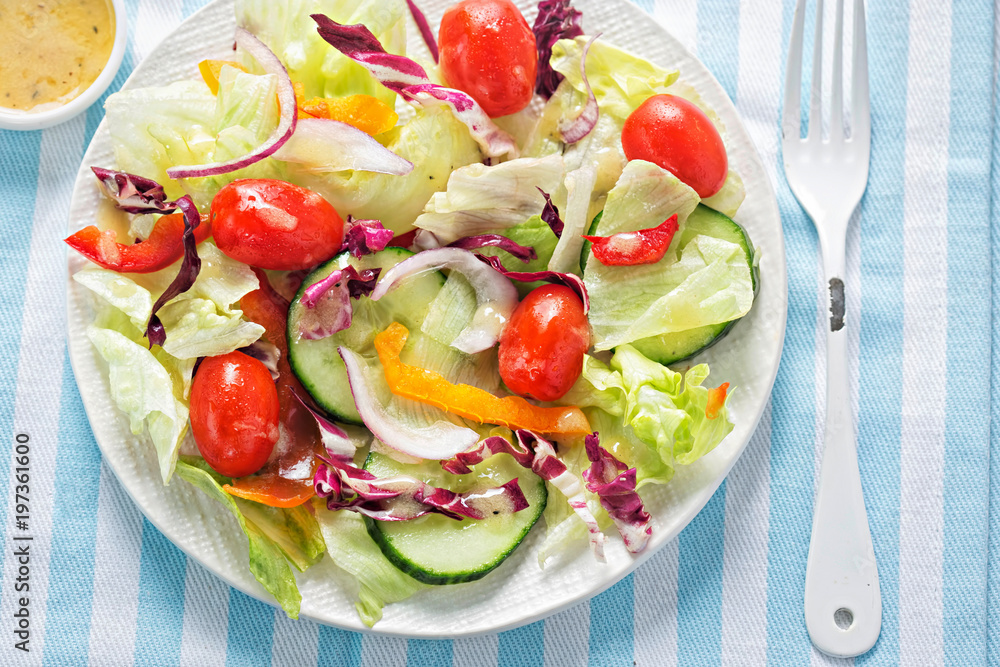 Mixed leaf salad with tomatoes, cucumber, peppers & red onion with French style dressing Mixed leaf salad with tomatoes, cucumber, peppers & red onion with French style dressing