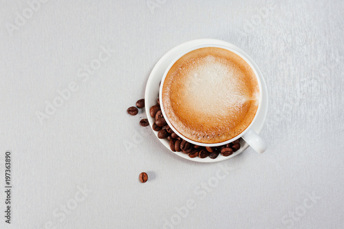 Top view of fresh cup of coffee and beans on table with free space for text. Banner. Coffeeshop