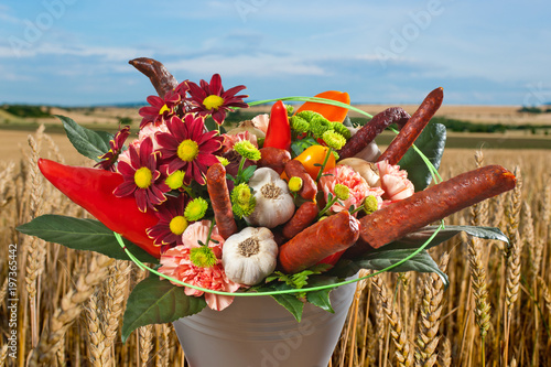 Obraz na plátně Bouquet of Flowers with Susages in the Vase