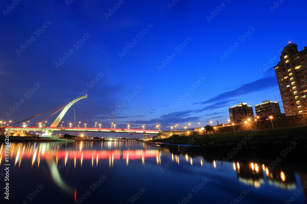 The famous cable-stayed Dazhi Bridge spanning over Keelung River at dusk in Taipei City Taiwan, Asia ~ A romantic landmark bridge of Taipei with beautiful reflections on smooth water under evening sky The famous cable-stayed Dazhi Bridge spanning over Keelung River at dusk in Taipei City Taiwan, Asia ~ A romantic landmark bridge of Taipei with beautiful reflections on smooth water under evening sky