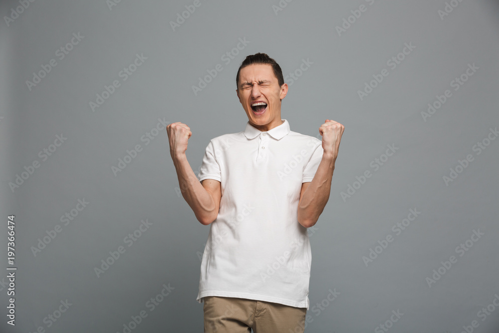 Excited young man make winner gesture. Excited young man make winner gesture.
