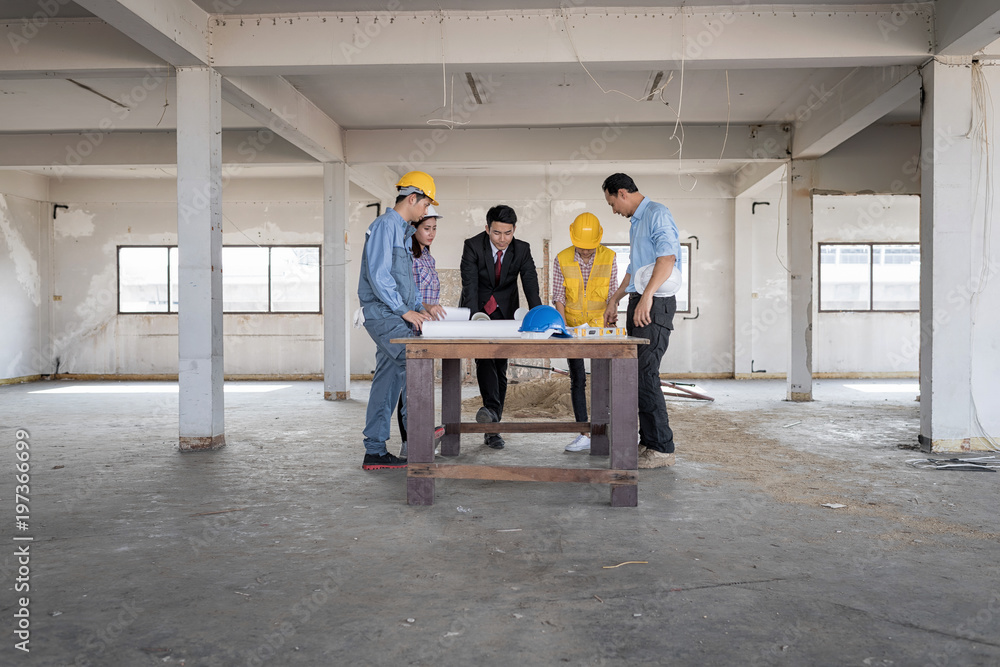 Businessman working with Architect Engineer in building Construction Site with blueprint.Checking project plan. Businessman working with Architect Engineer in building Construction Site with blueprint.Checking project plan.