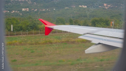 wing of the aircraft accelerates on the ground on the runway in Montenegro