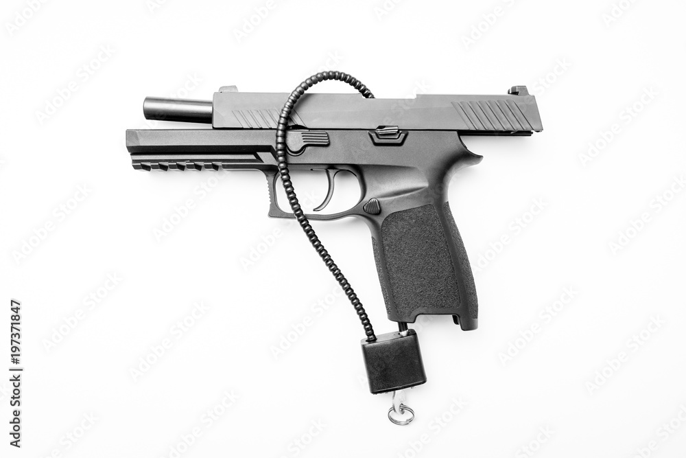 Locked disarmed secured handgun white background