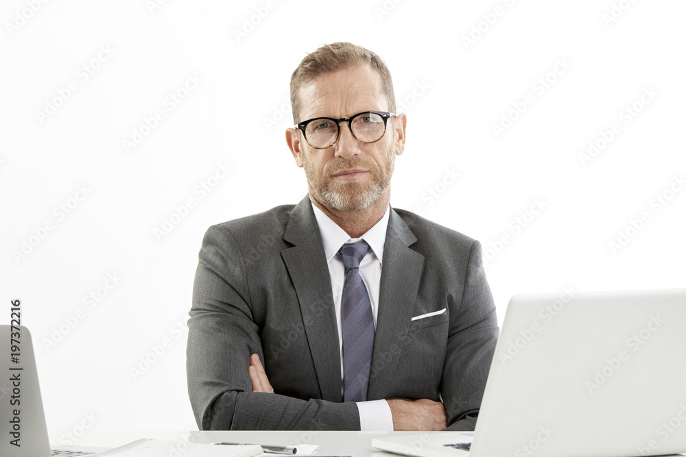 Businessman using laptops while working against white isolated background. Businessman using laptops while working against white isolated background.
