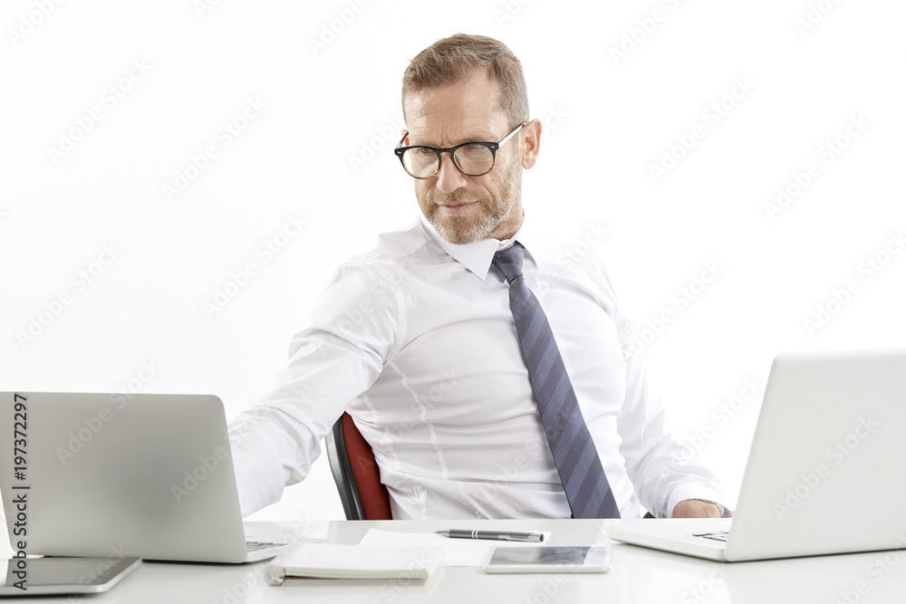 Businessman using laptops while working against white isolated background. Businessman using laptops while working against white isolated background.