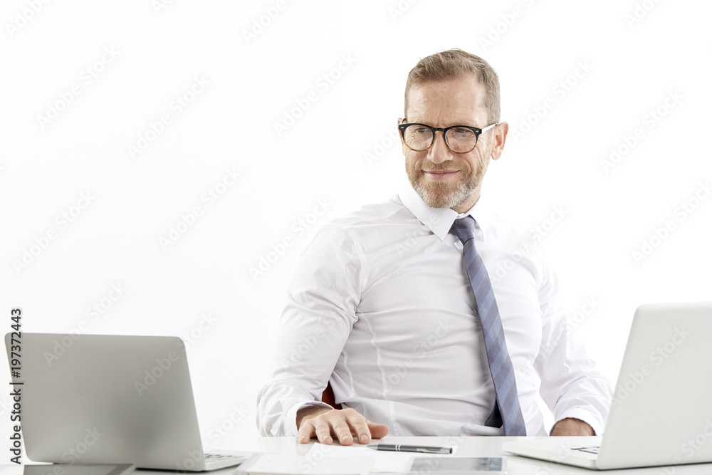 Businessman using laptops while working against white isolated background. Businessman using laptops while working against white isolated background.