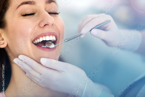 Woman having teeth examined at dentists
