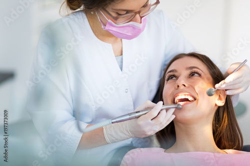 Dentist and patient in dentist office
 photo