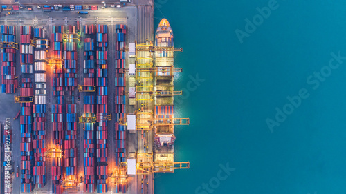 Container ship in export and import business and logistics. Shipping cargo to harbor by crane. Water transport International. Aerial view photo