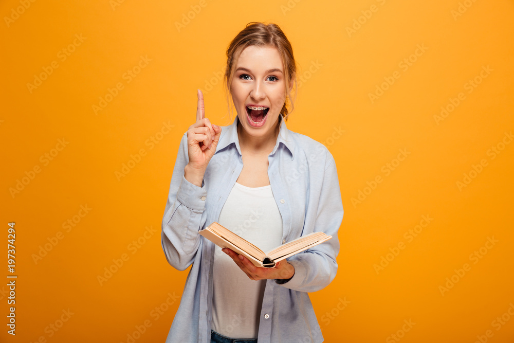 Excited young lady student reading book have an idea. Excited young lady student reading book have an idea.
