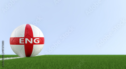 Soccer ball in english national colors on a soccer field. Copy space on the right side - 3D 