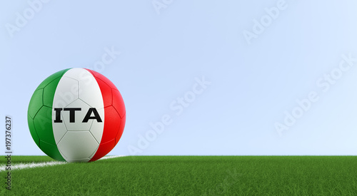Soccer ball in italys national colors on a soccer field. Copy space on the right side - 3D 