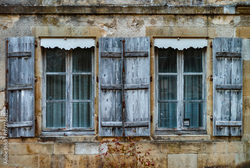 Old wooden windows with shutters in ancient freench city