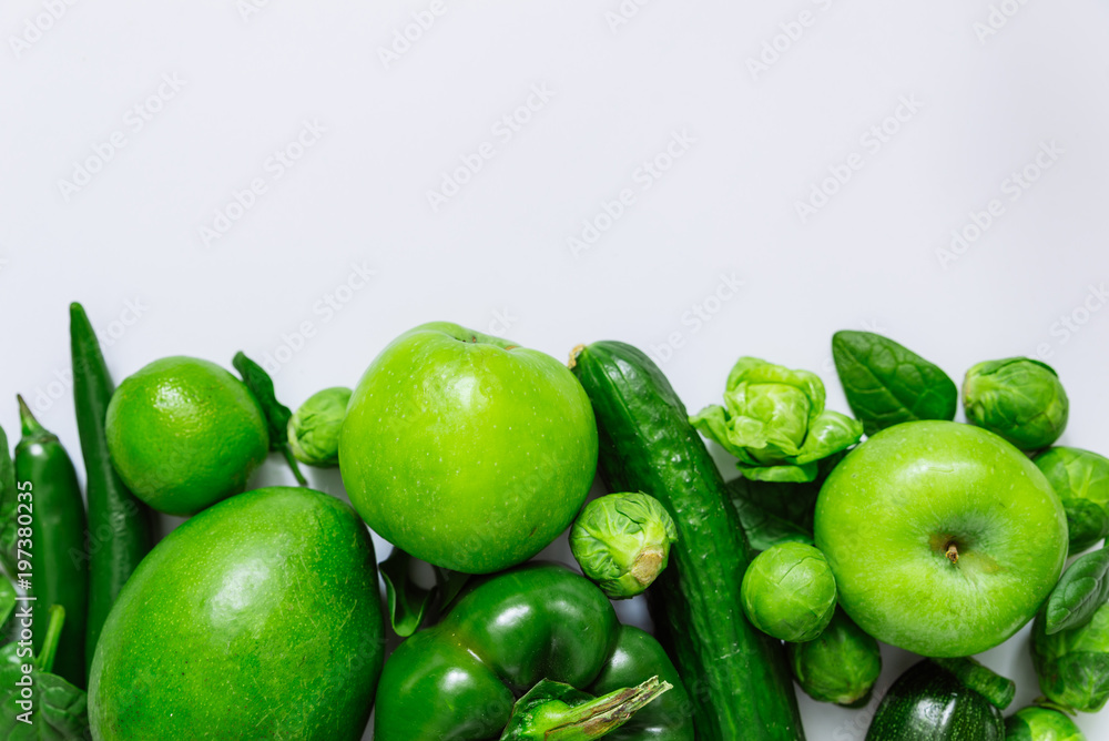 green fruits and vegetables on white background with copy space on top green fruits and vegetables on white background with copy space on top