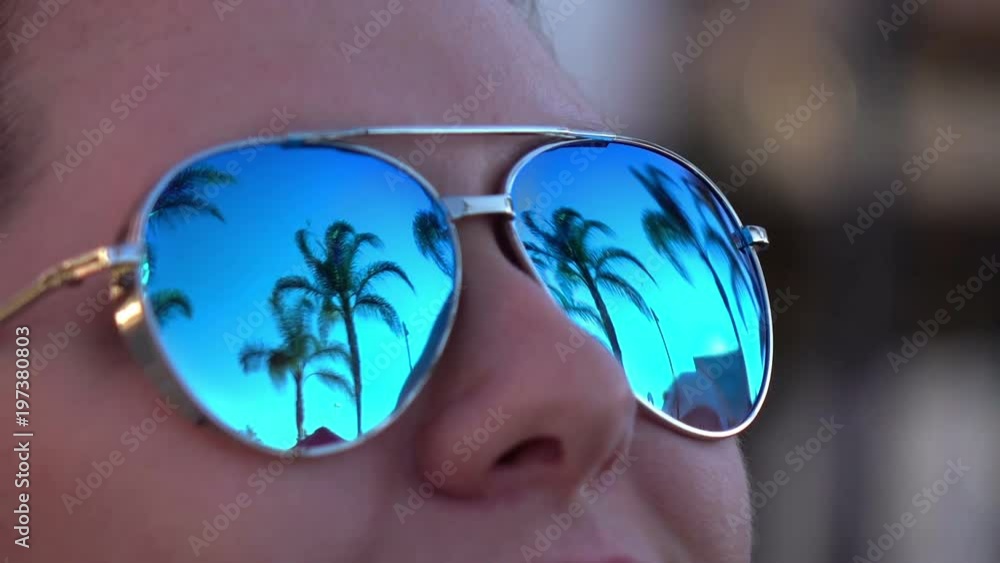 Professional video of woman in sunglasses looking at palm trees in slow motion 120fps Professional video of woman in sunglasses looking at palm trees in slow motion 120fps