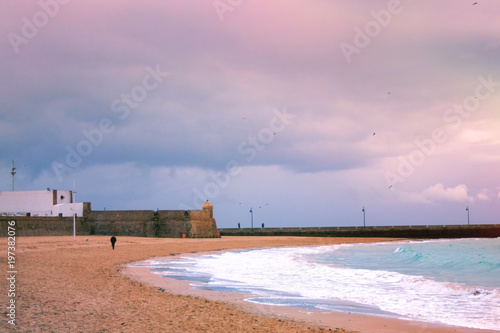 View of the lighthouse from the shore in cloudy weather