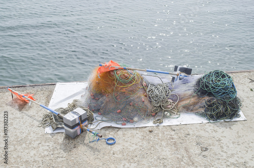 Colorful sea fishnet and flags on quay photo