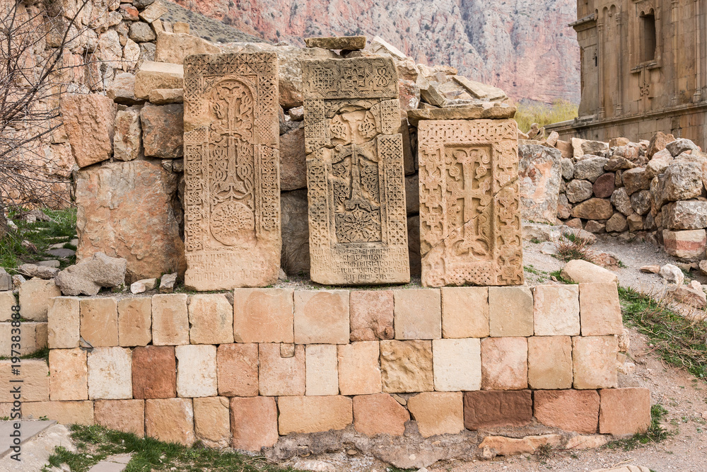 Old Armenian stone crosses, called 'khachkar' in scenic Novarank monastery in Armenia. Noravank monastery was founded in 1205