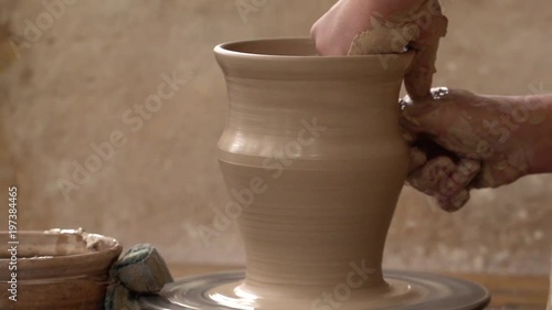 potter makes a brown pitcher